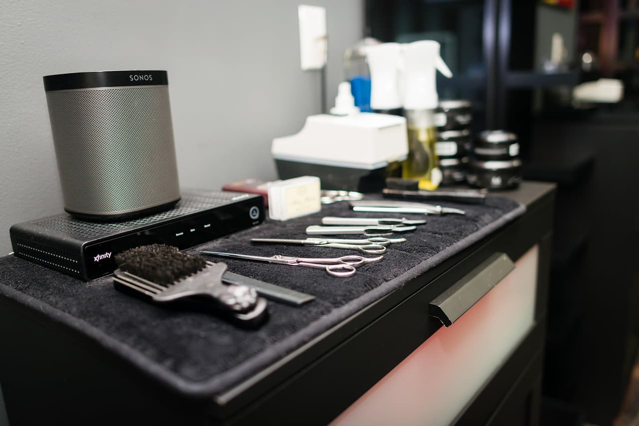 Clippers, combs and brushes laid out at a barber’s station